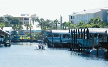  ?? JAY REEVES/AP PHOTOS ?? A boat cruises at a marina Tuesday in Mexico Beach, Fla., which was nearly wiped out by a storm in 2018.