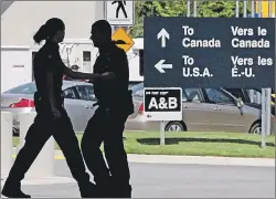  ?? CP PHOTO ?? Canadian border guards are silhouette­d as they replace each other at an inspection booth at the Douglas border crossing on the Canada-U.S. border in Surrey, B.C., in this 2009 file photo. Fewer Canadians are being turned away at the U.S. land border in recent months despite mounting concerns that Donald Trump’s immigratio­n policies are making it much harder to cross, The Canadian Press has learned.