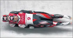  ?? AP PHOTO/MICHAEL SOHN ?? Justin Snith and Tristan Walker of Canada take a curve on their first run during the men’s doubles luge final at the 2018 Winter Olympics in Pyeongchan­g, South Korea, Wednesday.