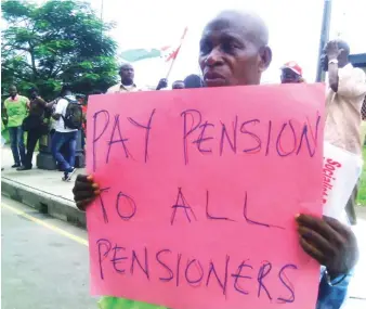  ??  ?? A pensioner with a placard in Osun recently