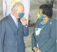  ?? IAN VOGLER GETTY IMAGES ?? Prince Charles is greeted by Barbados Gov. Gen. Sandra Mason as he arrives on Sunday in Bridgetown, Barbados.