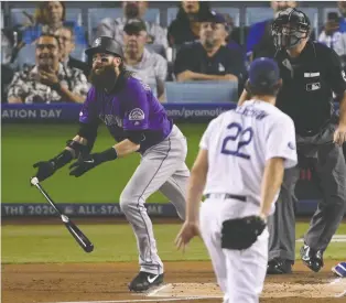  ?? MARK J. TERRILL/THE ASSOCIATED PRESS FILES ?? Colorado Rockies slugger Charlie Blackmon, in purple, contends he wouldn’t be such a great player if he wasn’t allowed to spit on the ground whenever he wants.