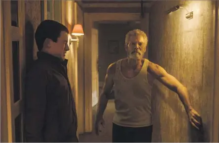  ?? Screen Gems ?? IN “DON’T BREATHE,” Dylan Minnette, left, portrays a home invader who runs afoul of the occupant, played by Stephen Lang.