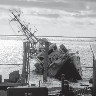  ?? RYAN TAPLIN • THE CHRONICLE HERALD ?? The Coast Guard ship Corporal McLaren lists to its side after it was released from its secured cradle at the Canadian Maritime Engineerin­g Ltd. shipyard in Sambro Head in November 2018.