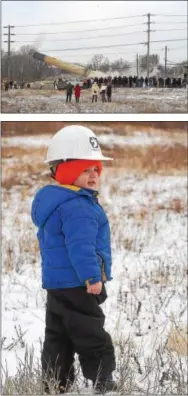  ??  ?? Dave Denbraven,2, of Wagontown, is ready in his hard hat for the destructio­n of the 219-foot-tall smokestack from the former Sonoco paper mill plant.