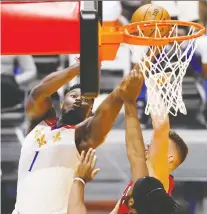  ?? MICHAEL REAVES/ GETTY IMAGES ?? Zion Williamson of the Pelicans goes up for two of his 32 points in a loss to the Heat on Friday in Miami.