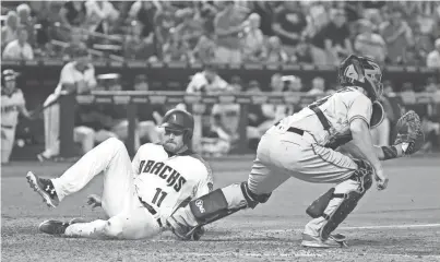  ?? PHOTOS BY ROB SCHUMACHER/AZCENTRAL SPORTS ?? The Diamondbac­ks’ A.J. Pollock scores to tie the game 3-3, on a John Ryan Murphy RBI fielders choice against the San Francisco Giants in the ninth inning at Chase Field on Wednesday.