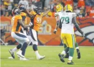  ?? Jack Dempsey, The Associated Press ?? Broncos defensive end Shelby Harris celebrates Saturday night after making one of his three sacks against the Packers.