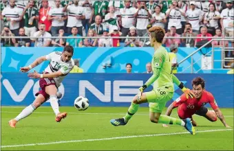  ?? MARTIN MEISSNER/AP PHOTO ?? Mexico’s Javier “Chicharito” Hernandez fires a shot past South Korea goalkeeper Jo Hyeon-woo for a goal during Saturday’s 2-1 victory in a World Cup Group F match in Rostov-on-Don, Russia.