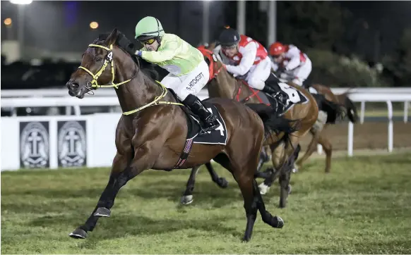  ?? Pawan Singh / The National ?? Sam Hitchcott, aboard Al Tiryaq, won the most valuable race of the night yesterday, the third race on the card at Abu Dhabi Equestrian Club