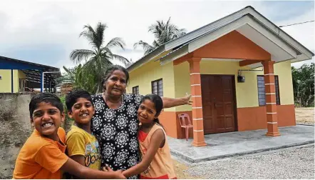  ??  ?? Home sweet home: Walliamah and her grandchild­ren (from left) S. Danush, S. Tarshan and S. Vidya can now look forward to a more comfortabl­e life at their new house in Kampung Baru Jementah, Segamat. Prior to that, Walliamah lived in a rundown house in...