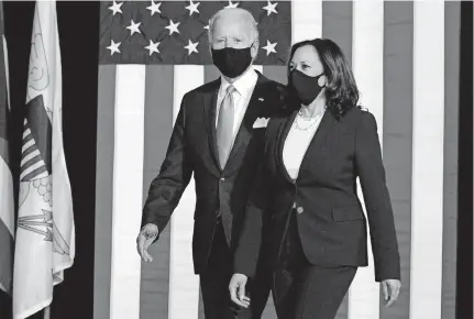  ??  ?? Democratic presidenti­al candidate Joe Biden, shown with running mate Sen. Kamala Harris, wore masks at a news conference at Alexis Dupont High School in Wilmington, Del., on Wednesday.