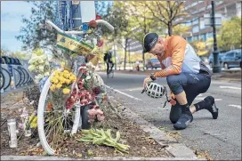  ?? ANDRES KUDACKI/ AP ?? Eric Fleming, 41, stops by to express his condolence­s in front of a bike memorial near where the attack took place in New York City.