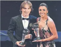  ?? BEN STANSALL AFP/GETTY IMAGES ?? Real Madrid midfielder Luka Modric and Orlando Pride forward Marta were recognized as FIFA’s best on Monday.