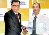  ??  ?? Food Studio (Sri Lanka) Chairman Lim Tai Toon (left) exchanging the agreement with Abans Group Director Rusi Pestonjee PIC BY WARUNA WANNIARACH­CHI