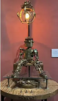  ?? ?? Fix Me, a Pete Daza robot sculpture, is made of brass, aluminum, iron, steel, copper, glass and mahogany wood. It is also made of 727 handmade pieces.