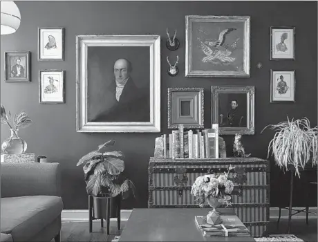  ?? E. JASON WAMBSGANS/CHICAGO TRIBUNE ?? Elise Maltby's collection of vintage portraits of men is featured on the living room wall of her Gold Coast apartment.