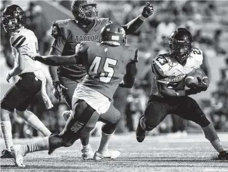  ?? Joe Buvid / Contributo­r ?? George Ranch running back Davion Jenkins, right, jukes past an Alief Taylor defender during the second half of Thursday’s game at Crump Stadium.