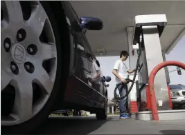  ?? MARCIO JOSE SANCHEZ — THE ASSOCIATED PRESS FILE ?? A motorist fuels up at a gas station in Santa Cruz on March 7, 2011.