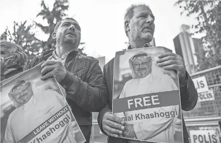  ?? OZAN KOSE/AFP/GETTY IMAGES ?? Protesters hold pictures of missing journalist Jamal Khashoggi during a demonstrat­ion in front of the Saudi Arabian consulate Oct. 5 in Istanbul.