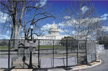  ?? Carolyn Kaster The Associated Press ?? The U.S. Capitol is seen behind security fencing Friday after a car crashed into a barrier on Capitol Hill, killing an officer.
