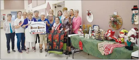  ?? (NWA Democrat-Gazette/Rachel Dickerson) ?? The ladies of St. Bernard Women’s Club are shown with some of their crafts that will be at the holiday bazaar on Nov. 4.