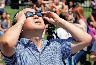  ?? BRUCE E STIDHAM/FOR THE NEWS-LEADER ?? Viewers at the Solar Eclipse Event at Plaster Stadium in Springfiel­d on Aug. 21, 2017.