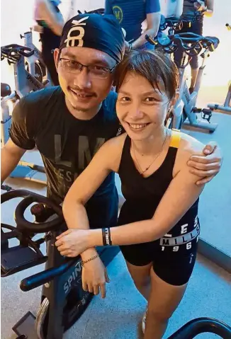  ??  ?? Keeping fit: Tan, who teaches group indoor cycling in the Klang Valley, with her husband Tan Keng Teck, at a cycling workshop recently.