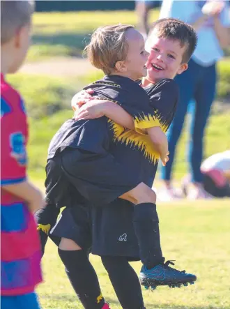  ??  ?? Mudgeeraba Soccer Club juniors playing the 'Mudgee Way". Picture: Supplied