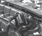 ?? J. SCOTT APPLEWHITE/ AP ?? Lawmakers take cover and prepare to evacuate the floor of the House of Representa­tives after what should have been an uneventful process of counting electoral votes turned into chaos.