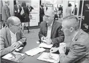  ?? [PHOTO BY JIM STAFFORD, FOR THE OKLAHOMAN] ?? Tom Kupiec, Ph.D., CEO of Oklahoma City-based ARL Bio Pharma and DNA Solutions, left, and Evan Fay, manager of innovation and entreprene­urship with the Greater OKC Chamber, meet with Javier Valesco, Ph.D., business developmen­t manager for Era7 Bioinforma­tics.