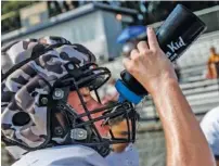 ?? STAFF PHOTO BY DOUG STRICKLAND ?? Chattanoog­a Christian football player Josh Elliott hydrates during a break at practice Thursday.
