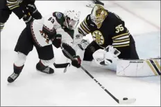  ?? MICHAEL DWYER — THE ASSOCIATED PRESS ?? Arizona Coyotes’ Matias Maccelli (63) tries to get a shot on Boston Bruins’ Linus Ullmark (35) during the second period of an NHL hockey game, Saturday, Dec. 92023, in Boston.