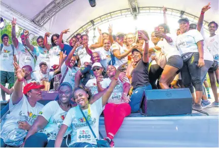  ??  ?? The UWI’s AZ Preston Hall team members are all smiles after copping the prize for second-largest team with 133 participan­ts.