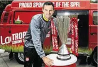  ??  ?? Bus stop: Joe Lewis with the Premiershi­p trophy