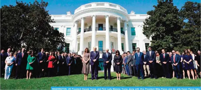  ??  ?? WASHINGTON: US President Donald Trump and First Lady Melania Trump along with Vice President Mike Pence and his wife Karen Pence take part in a moment of silence for the victims of the Las Vegas shootings, on the South Lawn of the White House. — AFP