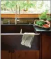  ?? HOUZZ ?? Sinks get a hard makeover with the use of concrete, stone and even granite in darker shades.