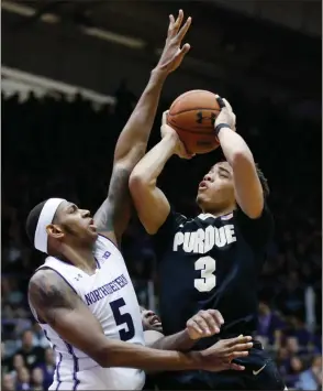  ?? Nam Y. Huh / The Associated Press ?? Purdue guard Carsen Edwards (right) shoots against Northweste­rn center Dererk Pardon during the first half of Sunday’s college basketball game in Evanston, Ill.