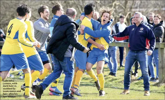  ?? PHOTO: CHRIS TOFALOS ?? Gabe Silva (centre, with dark hair) is mobbed by team-mates and fans after his late winner