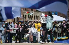  ?? SARAH REINGEWIRT­Z — STAFF PHOTOGRAPH­ER ?? Under the watch of Jewish students waving Israeli flags, UCLA students rally in their Palestinia­n solidarity camp on the Westwood campus on Thursday.