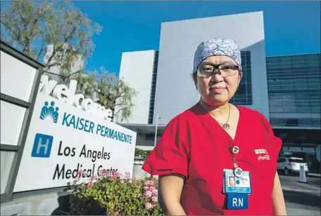  ?? MEL MELCON Los Angeles Times ?? REGISTERED NURSE Tinny Abogado, 46, who has worked at Kaiser Permanente in Los Angeles for more than 20 years, is worried about the mask supply. “We’re not prepared at all,” she said of the expected surge. “Besides being burned out, I’m also feeling nervous.”