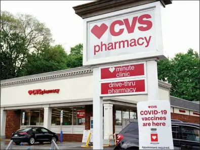  ?? (AP/Gene J. Puskar) ?? Vehicles are parked in front of a CVS Pharmacy in Mount Lebanon, Pa., in May. CVS Health said Thursday that hundreds of store closings will start next spring.