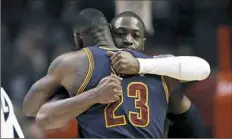  ?? Nam Y. Huh/Associated Press ?? Chicago Bulls guard Dwyane Wade, rear, hugs Cleveland Cavaliers forward LeBron James before the game Friday in Chicago.
