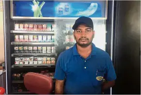  ??  ?? Doing his job: Selvam, remaining strong despite being slapped and scolded by customers who refused to stop smoking in the shop he is working in.