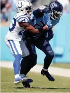  ?? ANDREW NELLES / TENNESSEAN.COM ?? Tennessee Titans running back Derrick Henry (22) is tackled by Indianapol­is Colts cornerback Kenny Moore II (23) at Nissan Stadium on Sept. 26, 2021 .