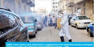  ??  ?? SANAA: Yemeni workers spray disinfecta­nt in a neighborho­od of the capital Sanaa during an emergency lockdown in certain areas due to the ongoing COVID-19 pandemic. — AFP
