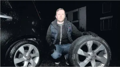  ??  ?? ●●David Melia with two flat tyres from his wife’s Nissan Note after the night of vandalism in Hazel Grove in February last year