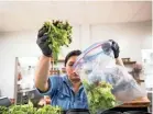  ??  ?? Interim Executive Director Kristin Mcmillin prepares salads at Caritas Community Center and Cafe in Binghampto­n last Tuesday. Mcmillin cut short a vacation to help provide free meals to Memphians.