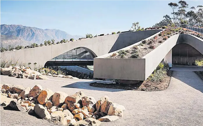  ?? Picture: ELLE DECOR ?? The house rises as a hill with the amphitheat­er at the basement level and a green roof garden above.