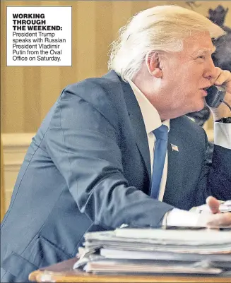  ??  ?? WORKING THROUGH THE WEEKEND: President Trump speaks with Russian President Vladimir Putin from the Oval Office on Saturday.